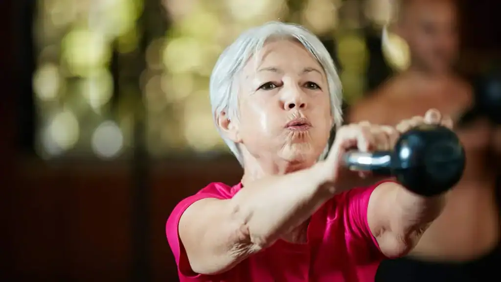 Older woman doing weight training Bexleyhill to help her strength and longevity 