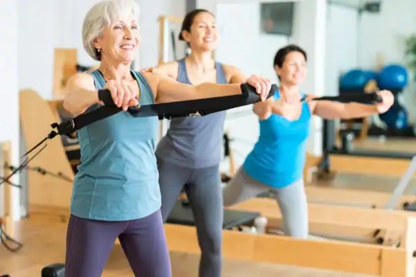 older woman doing weight training Bexleyhill and resistance in the gym to tone upper arms
